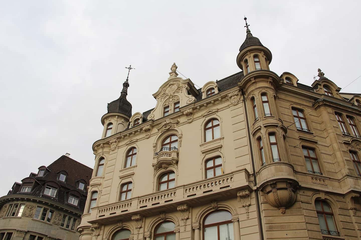An ornate commercial building with bay windows and turrets on Marktplatz in Basel