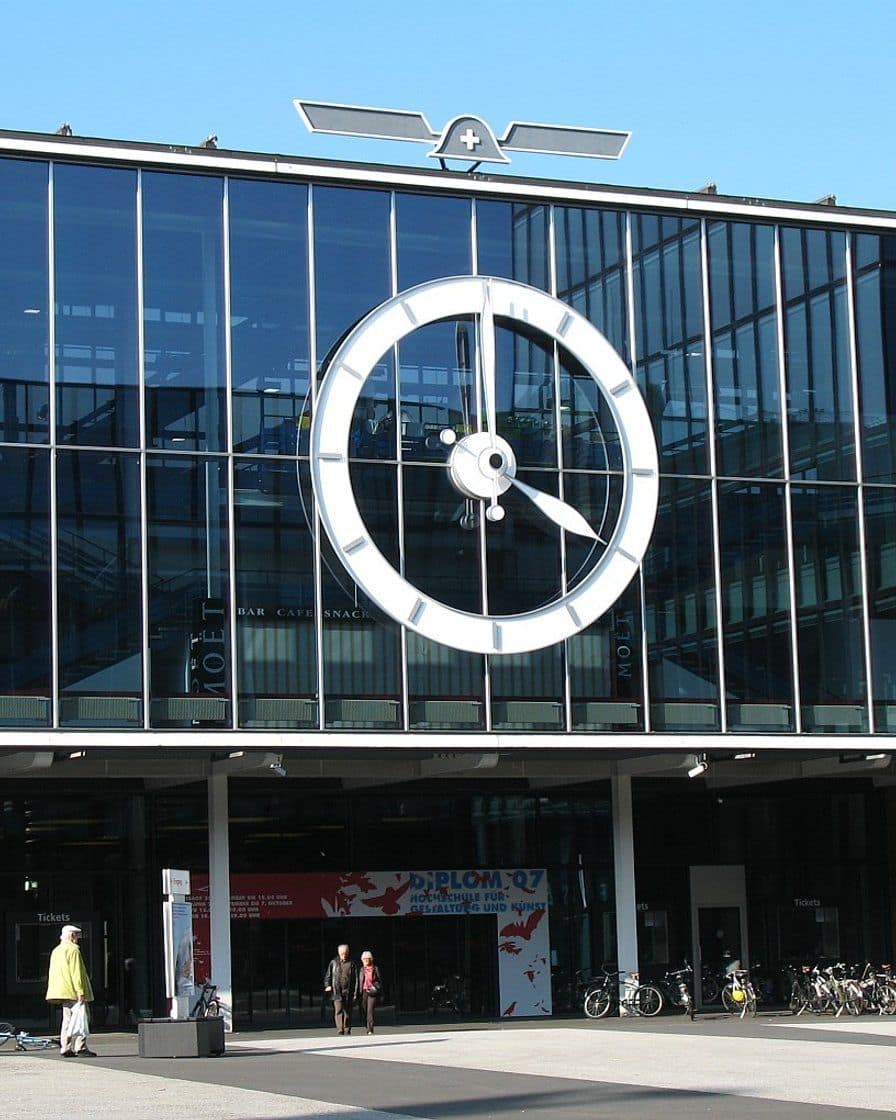 The glass facade of Messe Basel with its large clock